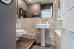 Bathroom with bath and shower over